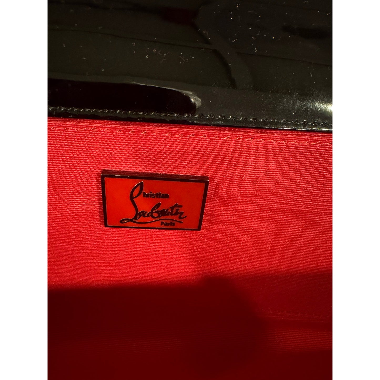 Christian Louboutin Pigalle spiked clutch is crafted from black patent leather and accented with black studs